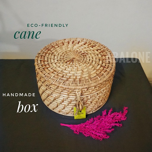 a hand woven round organic cane box with lid