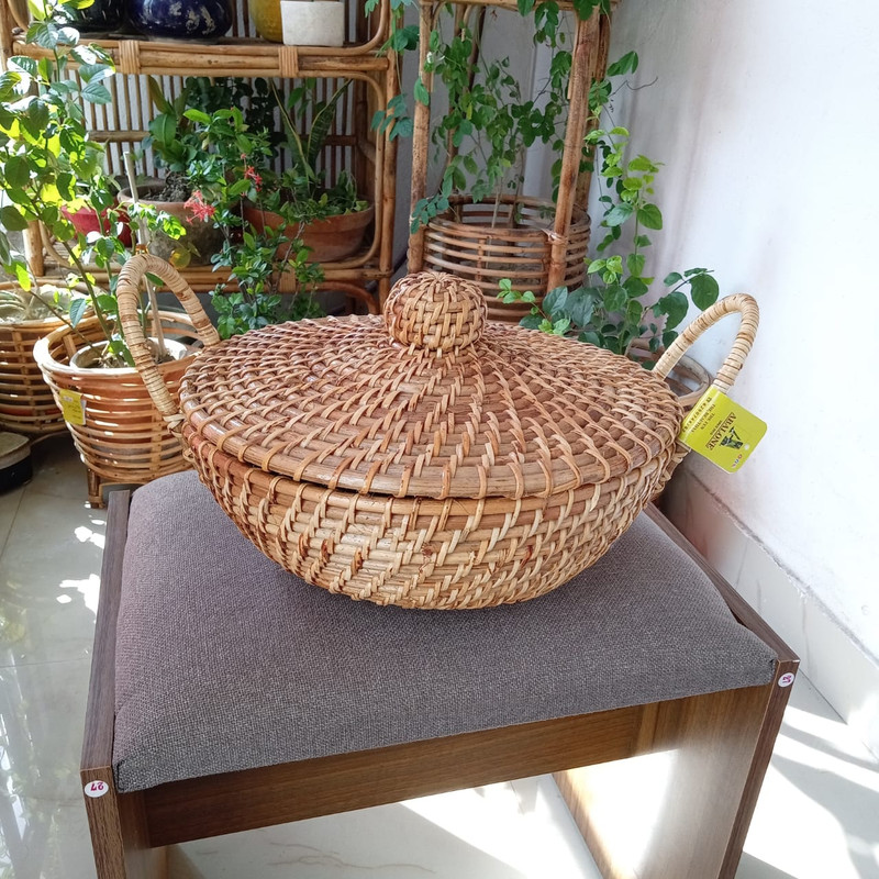 A round Cane Basket with lid and handle for kitchen decor