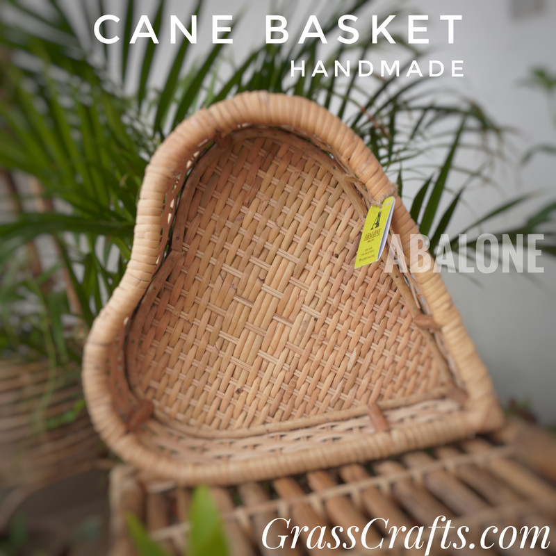 a handmade heart shaped cane basket