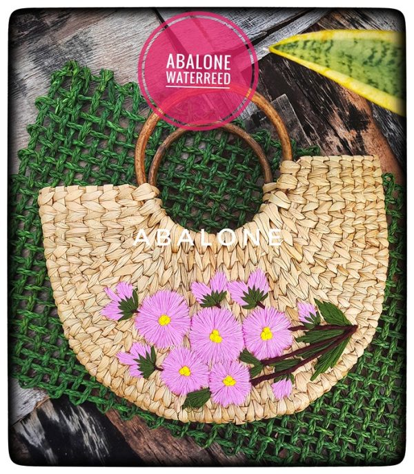 a hand woven kauna handbag with flowers embroidered on it