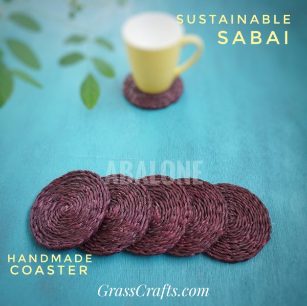 set of handmade sabai coasters with a yellow cup on a blue surface
