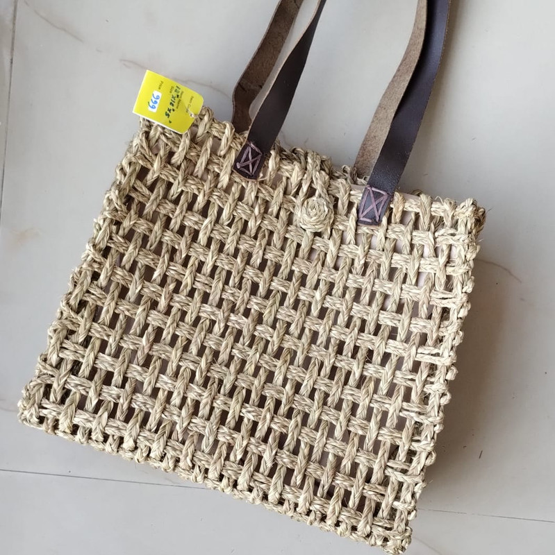 a handmade sabai tote bag with leather handle